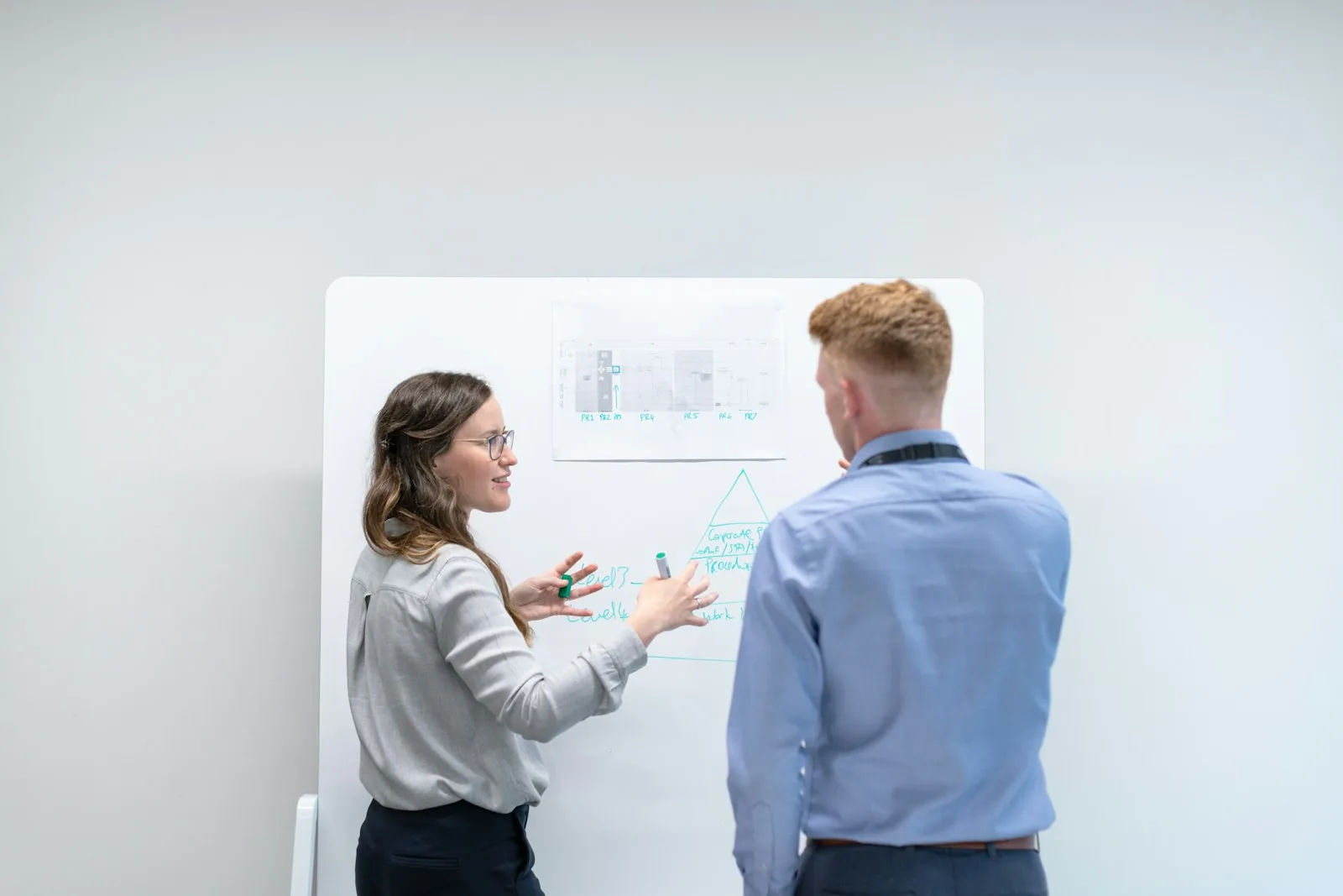 Two engineers exploring ideas together at a whiteboard.