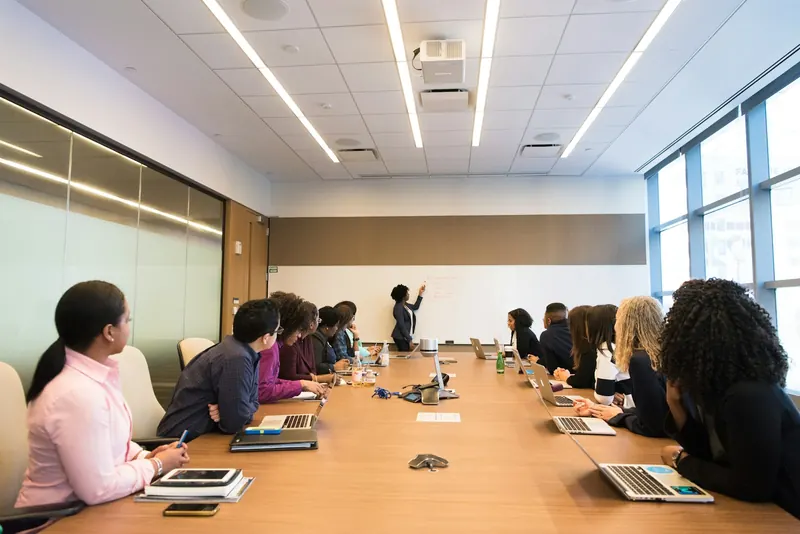 Business professionals discussing a project together around a conference table